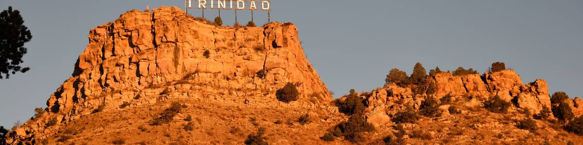 A rocky hill with the sign 'TRINIDAD' at the top.