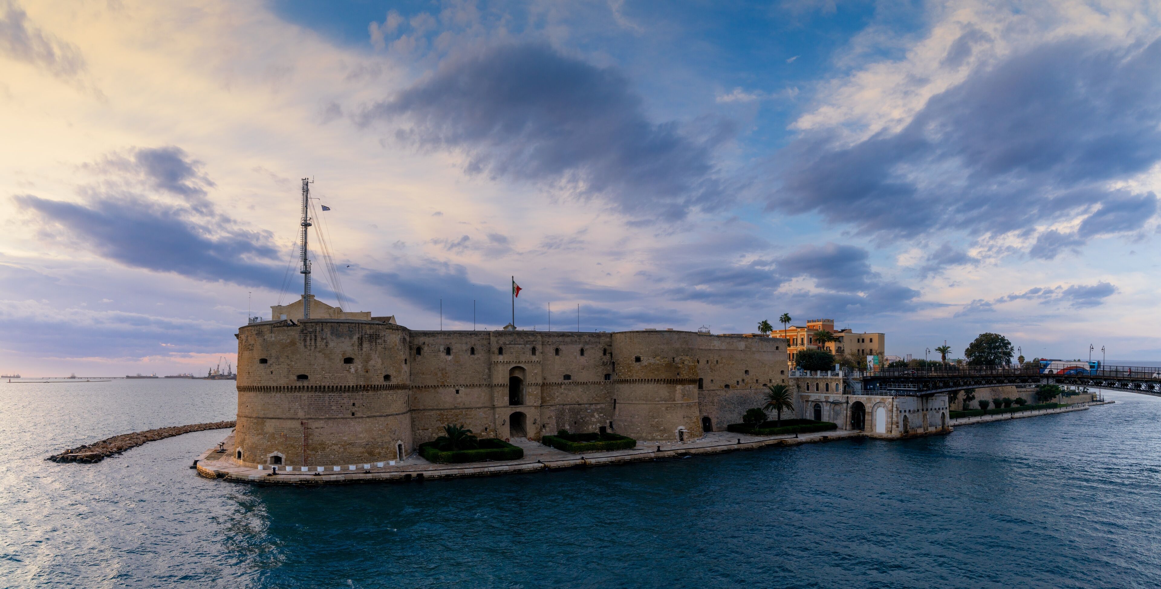 A historic fortification by the sea with a clear sky and calm waters.