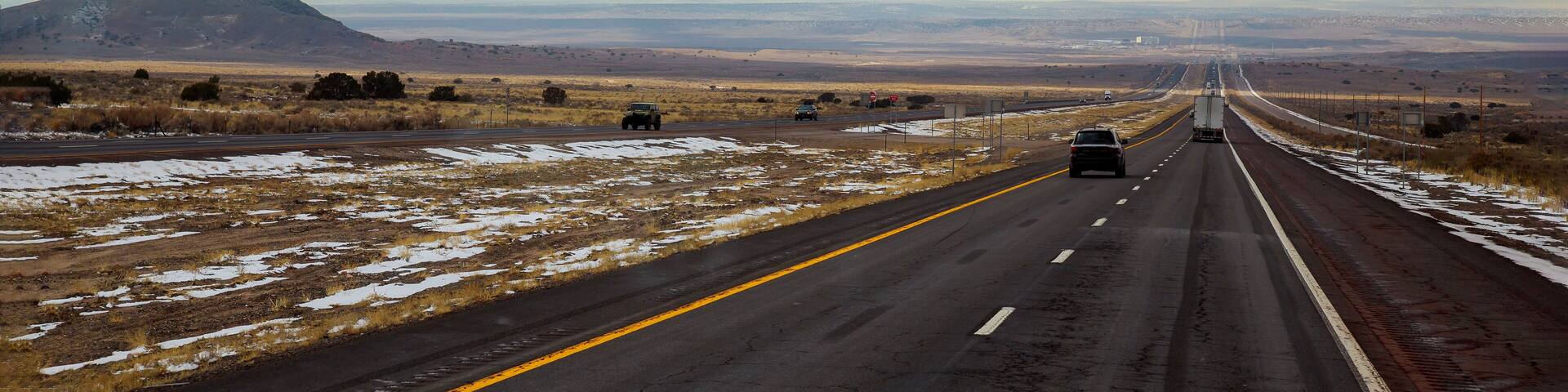 A highway runs from Tucumcari, New Mexico through the brush and mesas of the high desert.