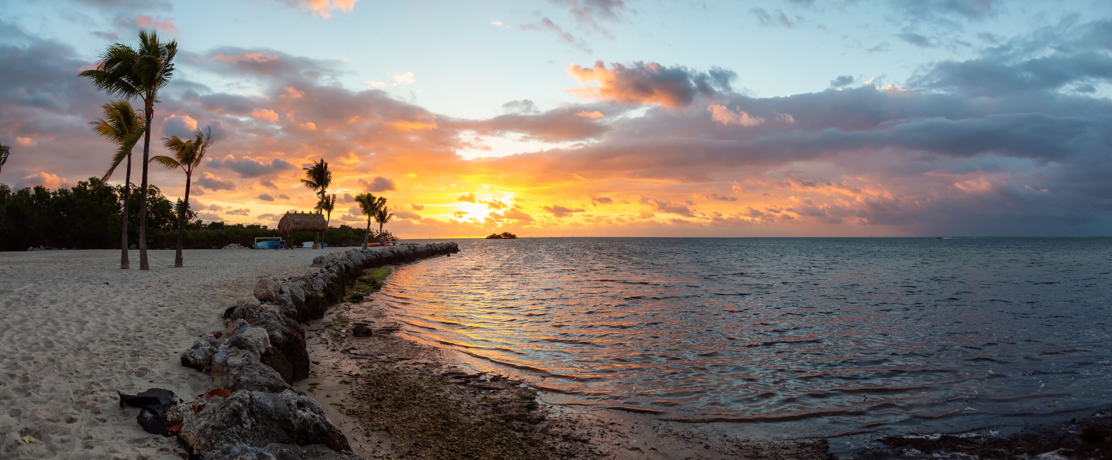 Striking sunrise viewed on a tropical sandy beach at the Atlantic Ocean Shore. Plantation Key, Florida Keys, Florida, United States.