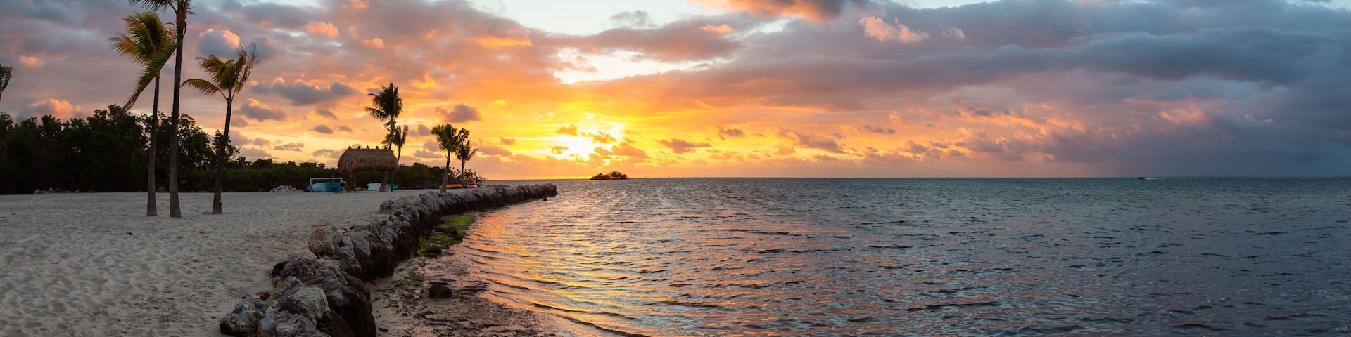 Striking sunrise viewed on a tropical sandy beach at the Atlantic Ocean Shore. Plantation Key, Florida Keys, Florida, United States.