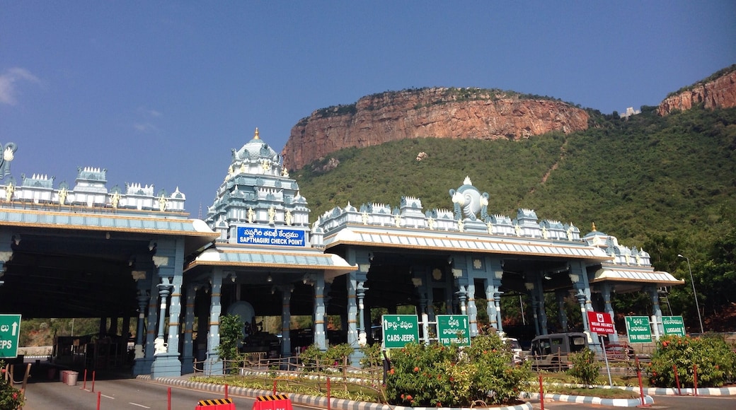 A temple with a large rock formation in the background.