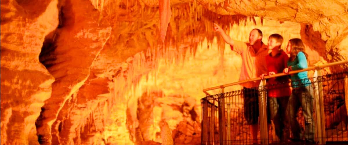 A group of people observing cave formations.