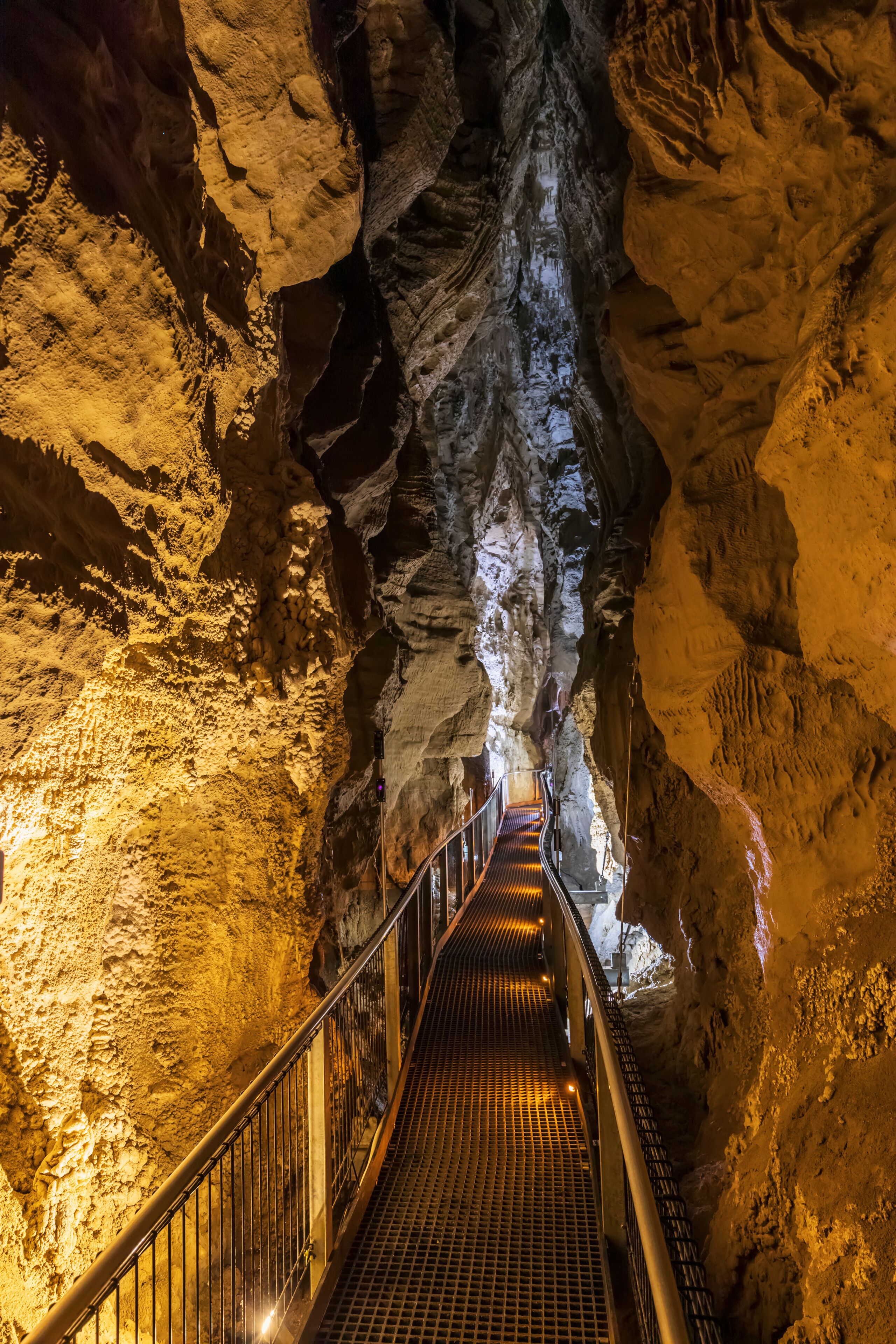 New Zealand, Oceania, North Island, Waitomo Caves, Ruakuri Cave, Narrow walkway and limestone formations in cave