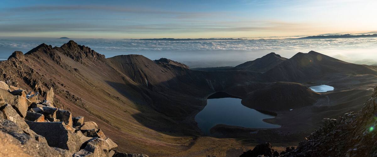 A mountain landscape with a lake and rocky terrain.