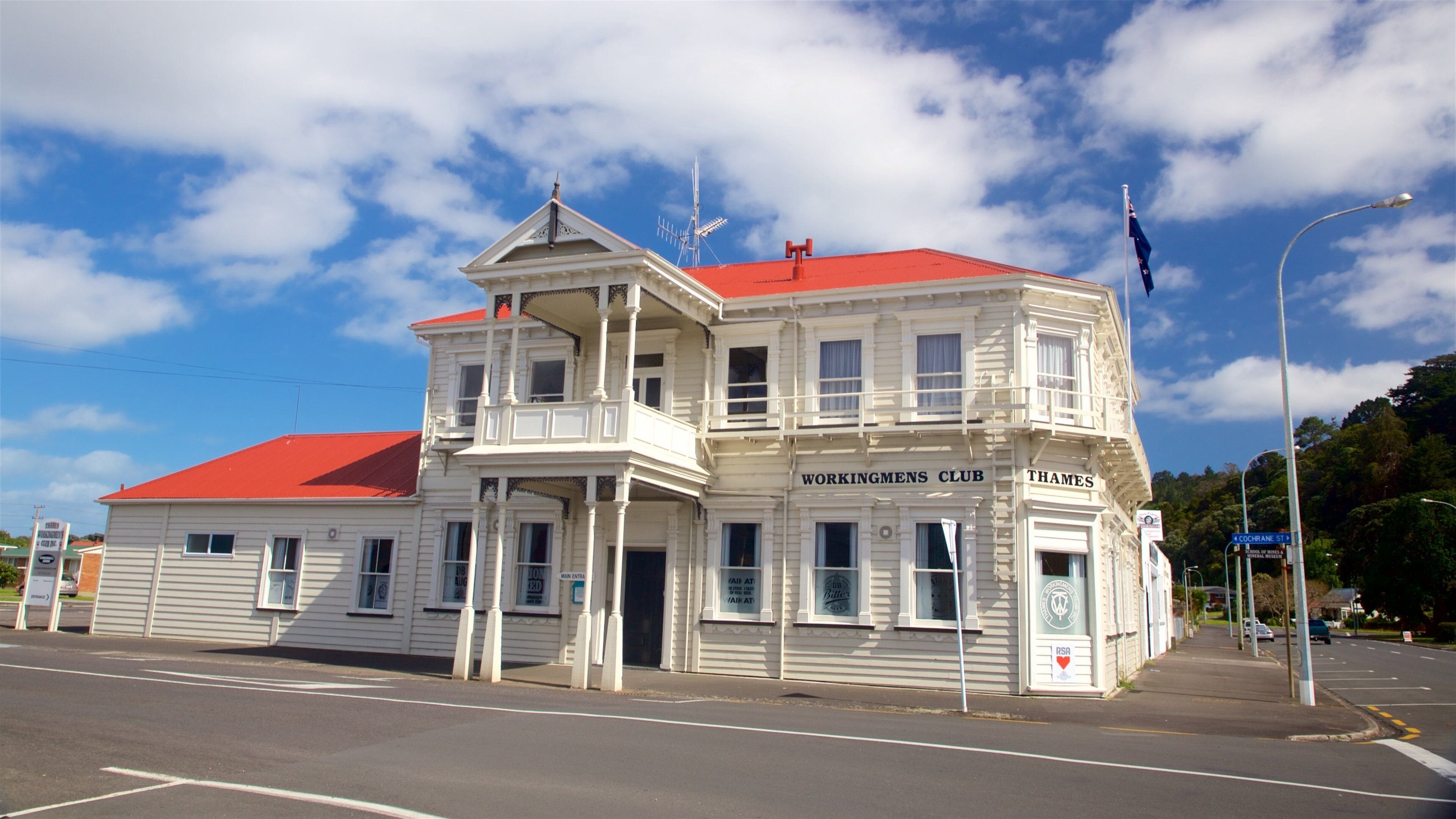 A white building with a red roof, named 'Workingmens Club' in 'Thames'.