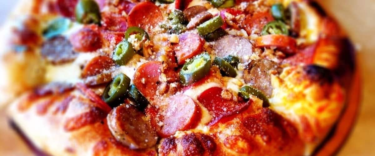 andouille sausage, pepperoni, roasted garlic, jalapeno, olive pizza