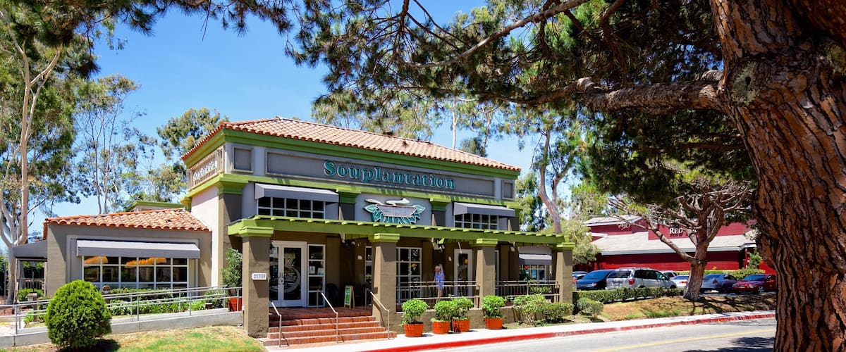 A building named 'Souplantation' with a green facade and a red-tiled roof.