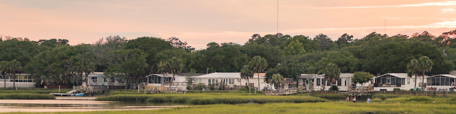 Murrells Inlet showing a small town or village, wetlands and a sunset
