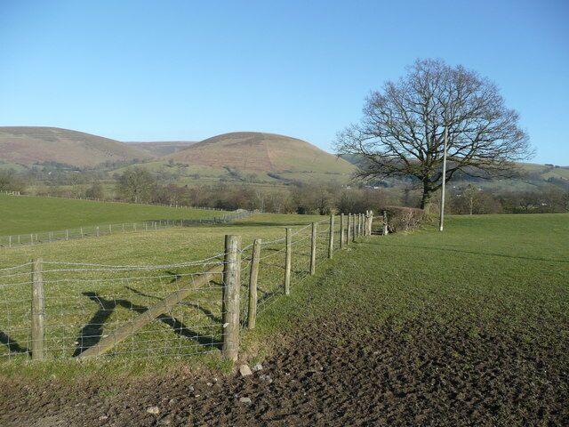 View east to Foel Looking across pastures around Lower Trewern to the east of the A44. The rounded hills, of which Foel is the one in the centre, that make up the Radnor Forest group, frame the scene.