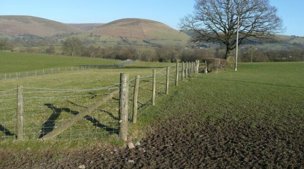 View east to Foel Looking across pastures around Lower Trewern to the east of the A44. The rounded hills, of which Foel is the one in the centre, that make up the Radnor Forest group, frame the scene.