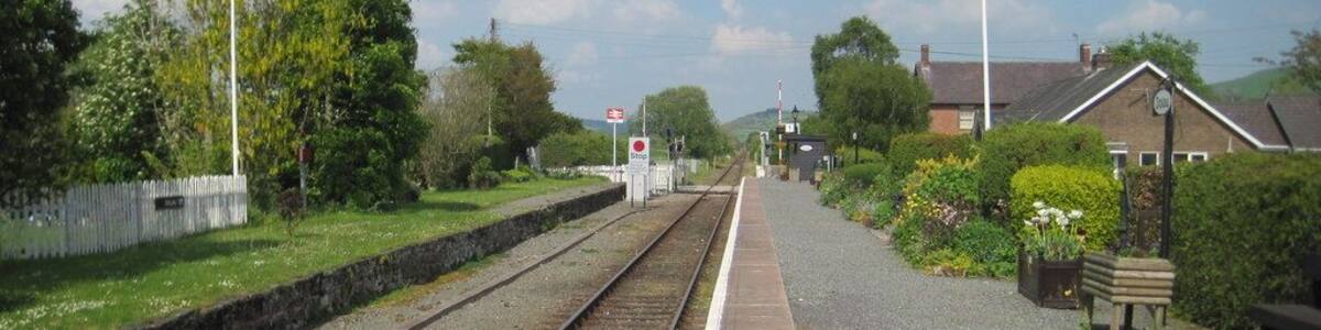 Dolau railway station, Powys Opened in 1865 by the Central Wales Railway on what became today's line from Swansea to Craven Arms and Shrewsbury. View north east towards Llanbister Road and Craven Arms. The disused platform to the left is the former northbound platform.