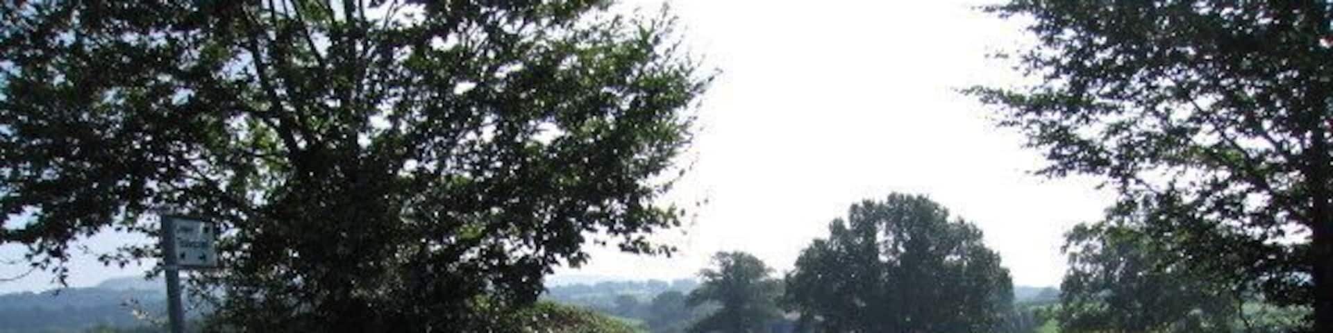 To the farm Junction with a dead end lane that runs roughly alongside the eastern side of the square.