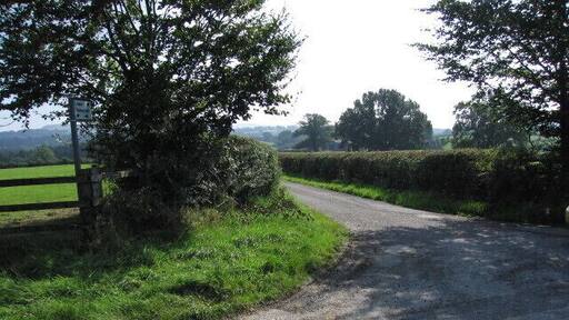 To the farm Junction with a dead end lane that runs roughly alongside the eastern side of the square.