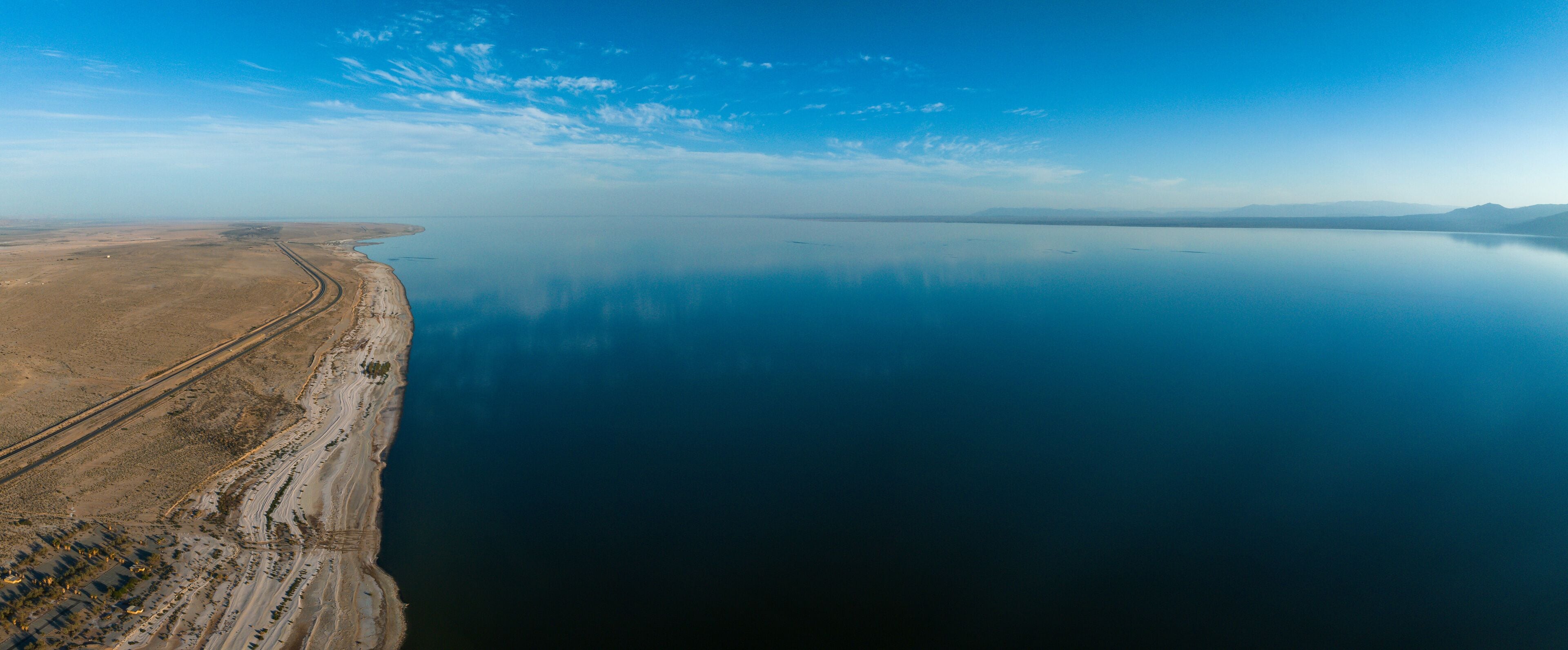 Aerial view over Salton sea in California. Huge lake in the middle of a desert at sunset.