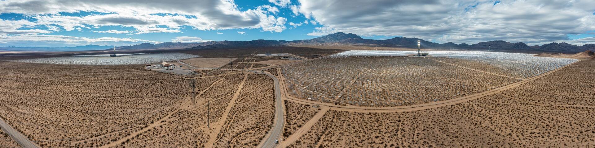 Drone panorama over Ivanpah solar thermal power plant in California during daytime sunshine