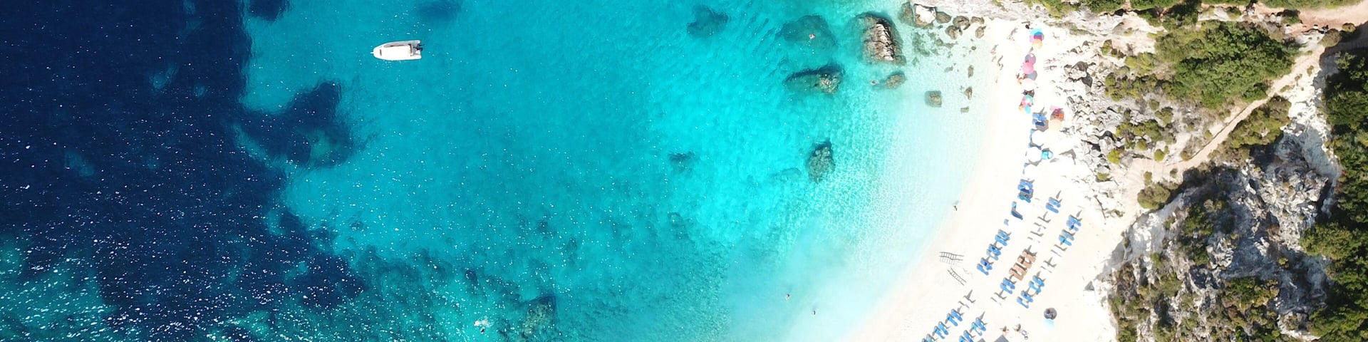 Aerial drone photo of tropical exotic caribbean paradise vegetated island with blue lagoon turquoise sea and sail boats