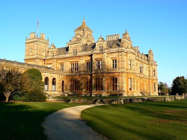 A large, ornate building with a prominent tower and arched windows.