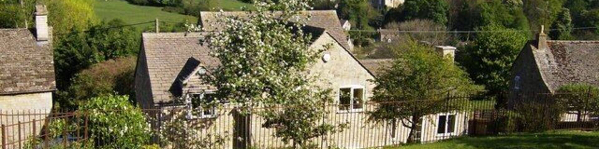 Leaving Avening A footpath heads south from a newer part of Avening. The houses are built to reflect the lie of the land in this quite hilly village.