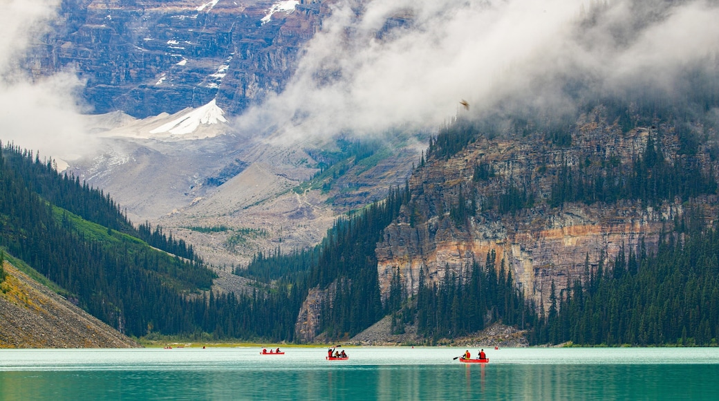 Lake Louise which includes mist or fog, mountains and boating