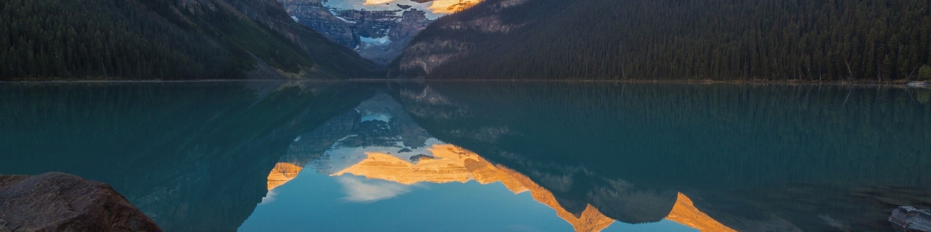 A beautifully still morning at Lake Louise. As the sun rises its rays turn the mountains behind the lake golden. A t=truly magical experience although it does get extremely busy.... there was a whole line of people capturing this moment in time... #reflections