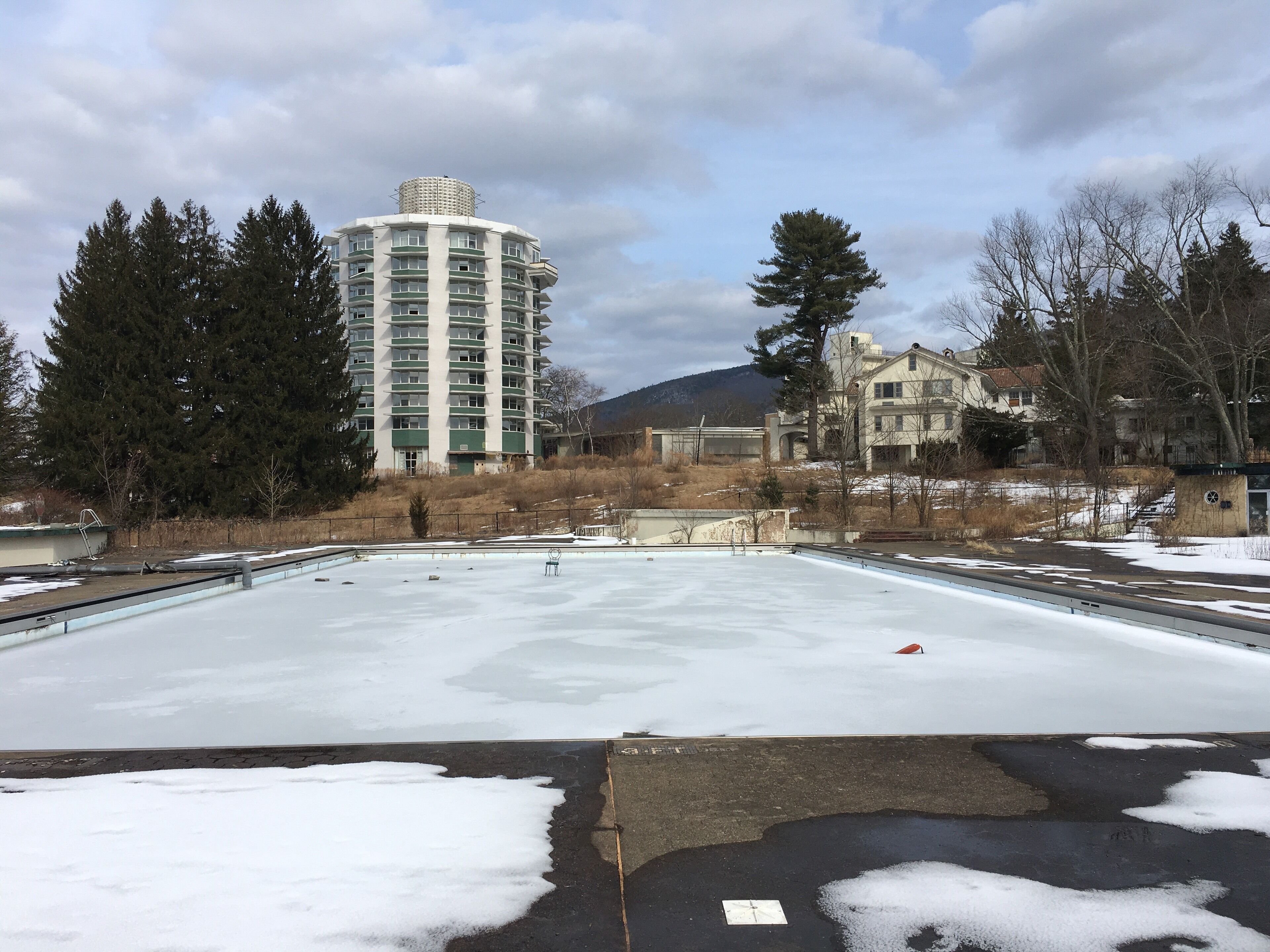 A large, open, frozen plaza with a tall building in the background.