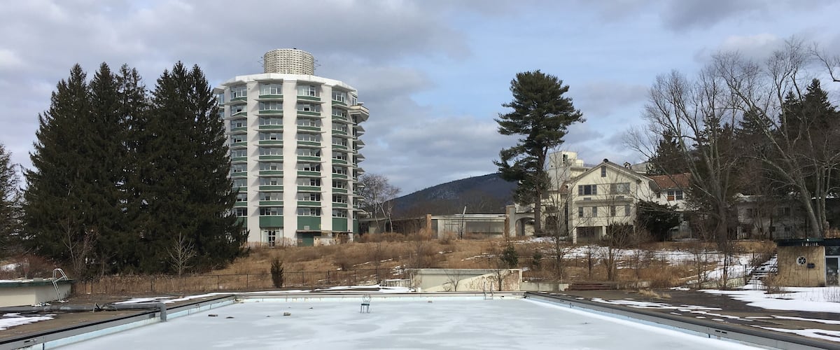 A large, open, frozen plaza with a tall building in the background.