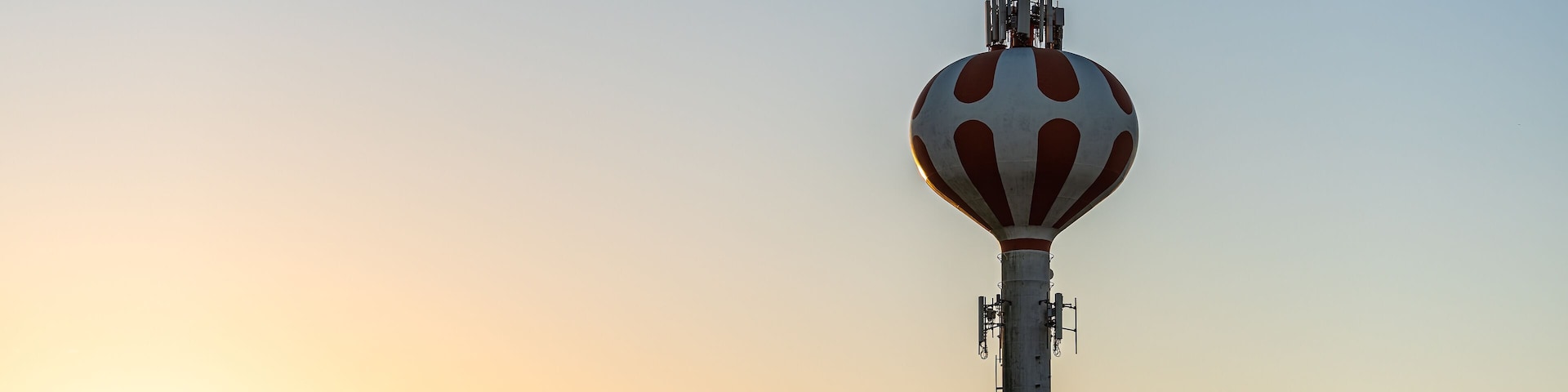 Pooler, Georgia water tower in city near Savannah with dark dawn blue sky at sunrise with golden yellow light landscape view with nobody