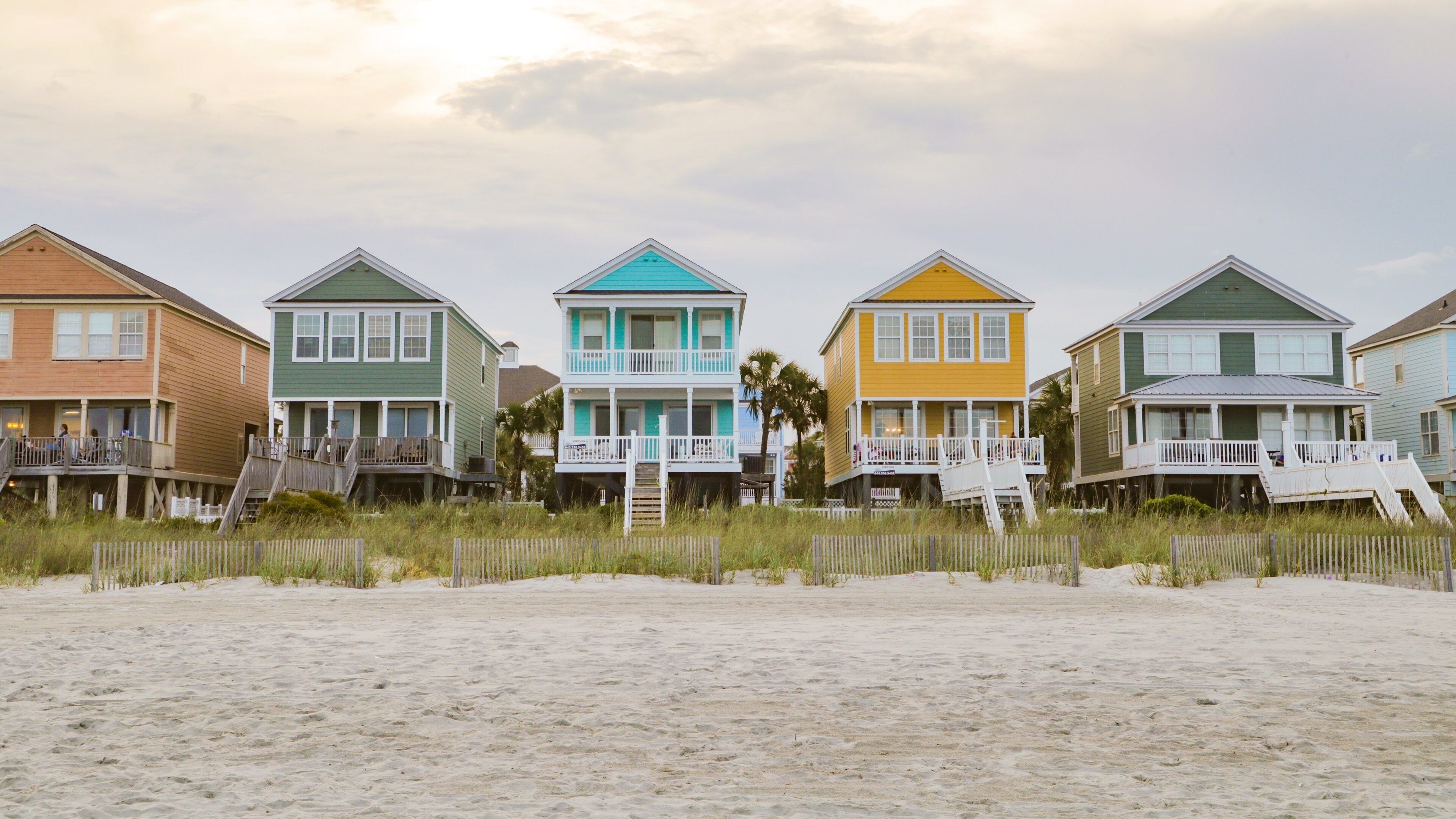 Surfside Beach showing a sunset, a coastal town and a sandy beach