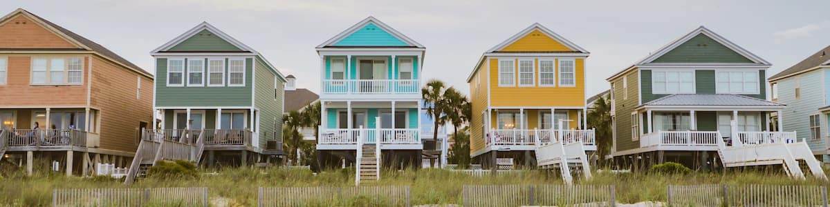 Surfside Beach showing a sunset, a coastal town and a sandy beach