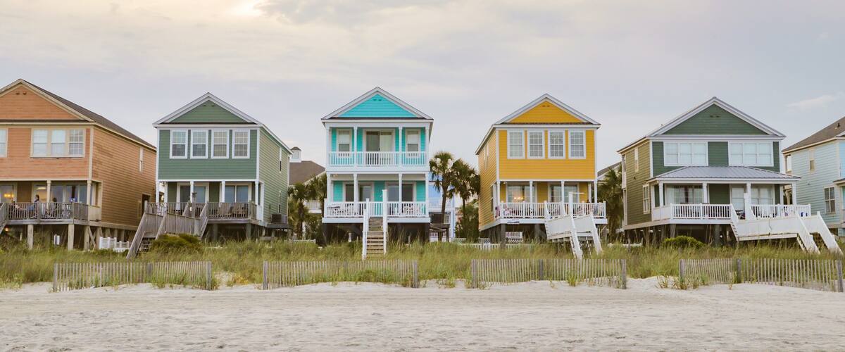 Surfside Beach showing a sunset, a coastal town and a sandy beach