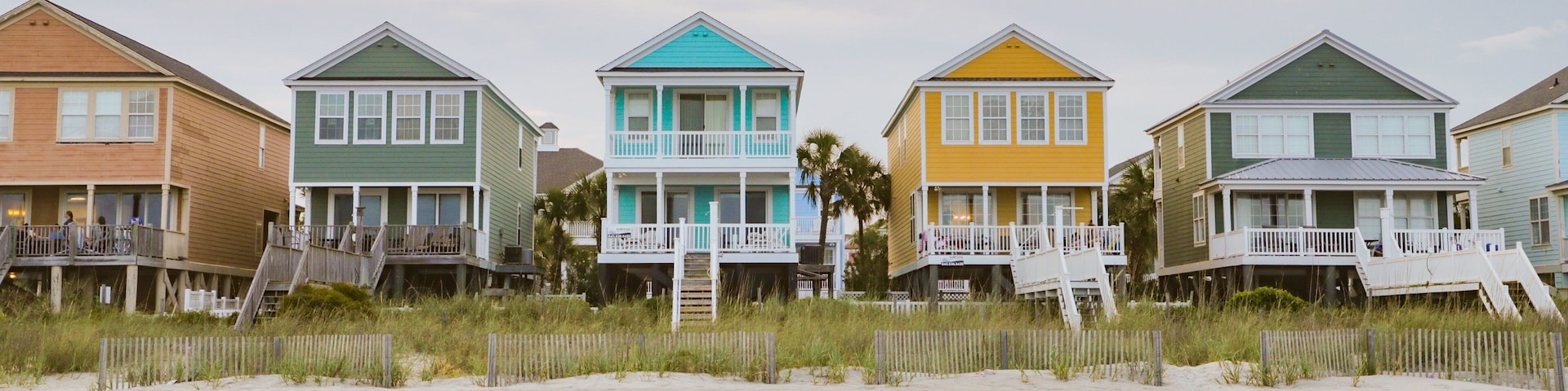 Surfside Beach showing a sunset, a coastal town and a sandy beach