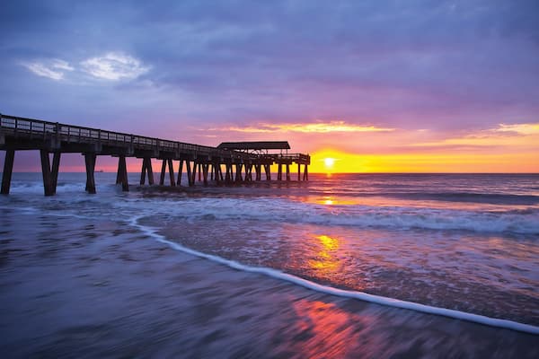 Tybee Island showing a sandy beach, skyline and a sunset