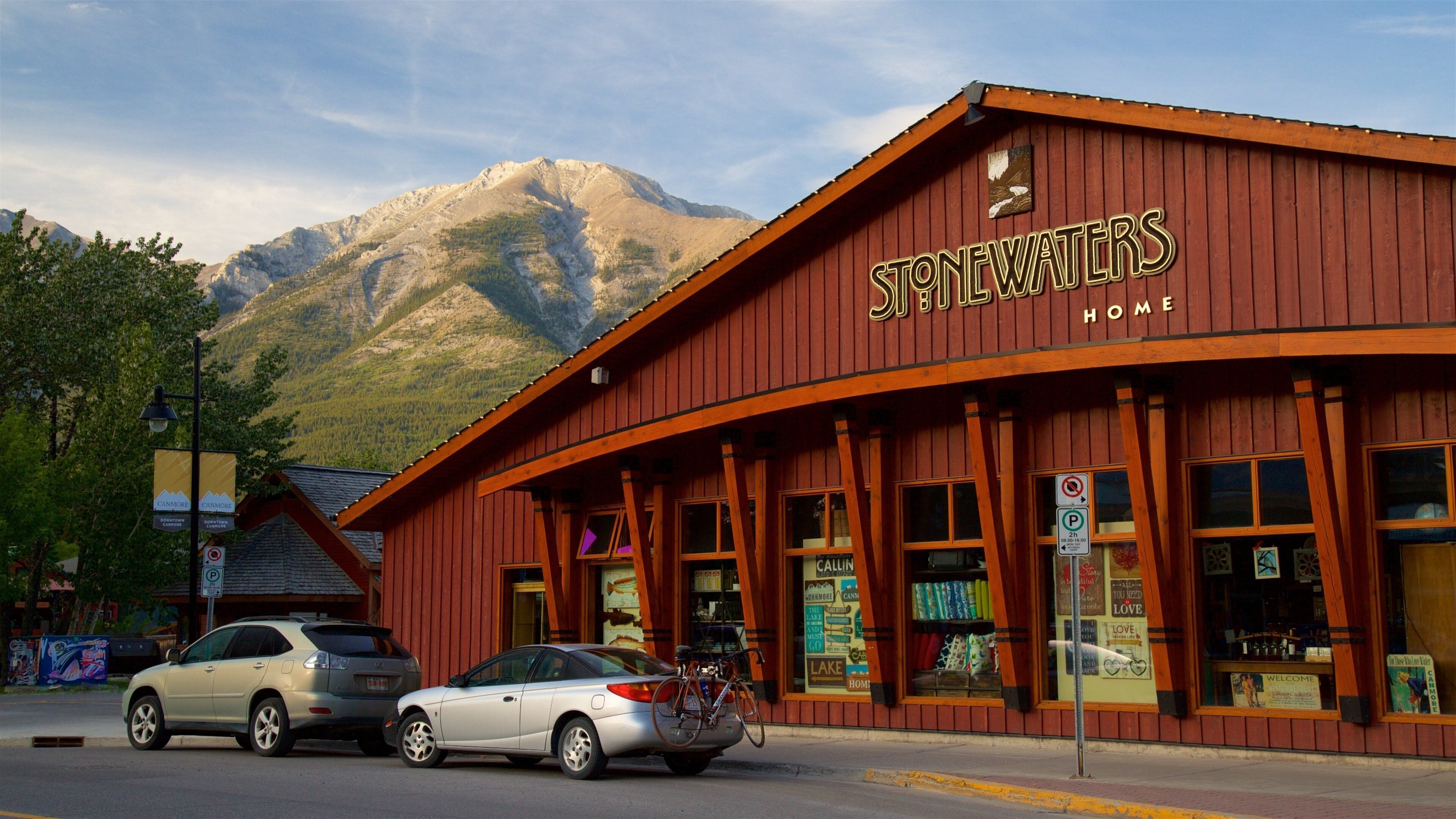 A red building with the sign "Stonewater's Home" and a mountain in the background.