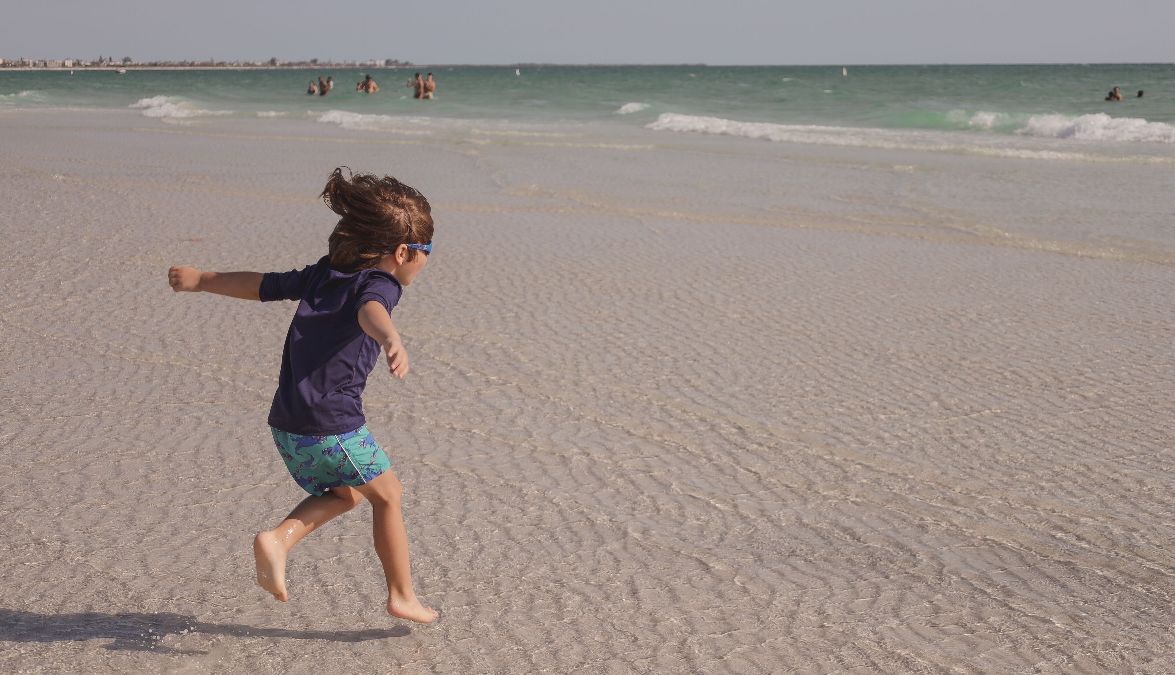 boy playing on Sunset Beach  located at the southern tip of Treasure Island, Florida in Pinellas County.