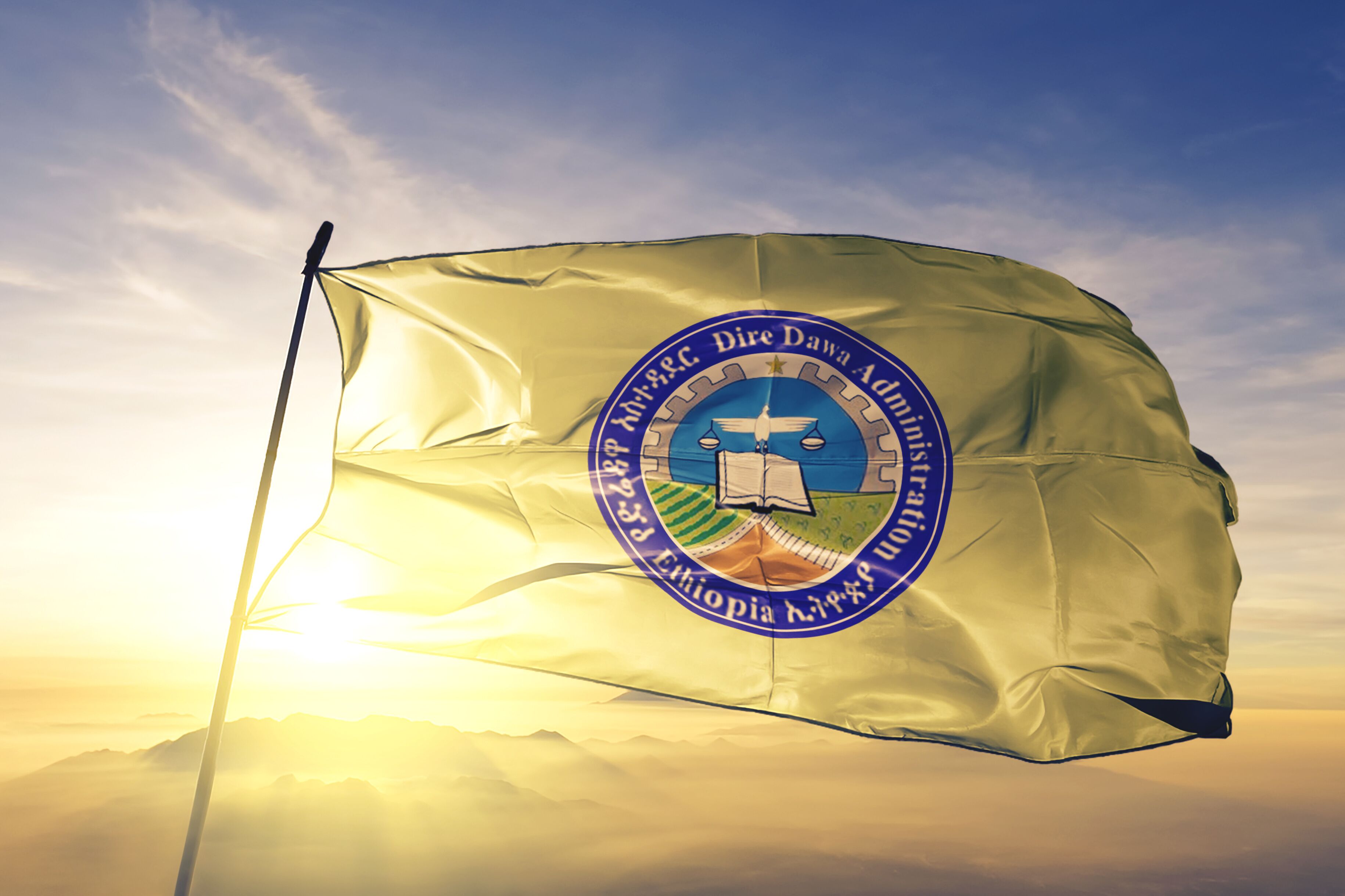 Dire Dawa city of Ethiopia flag waving on the top sunrise mist fog