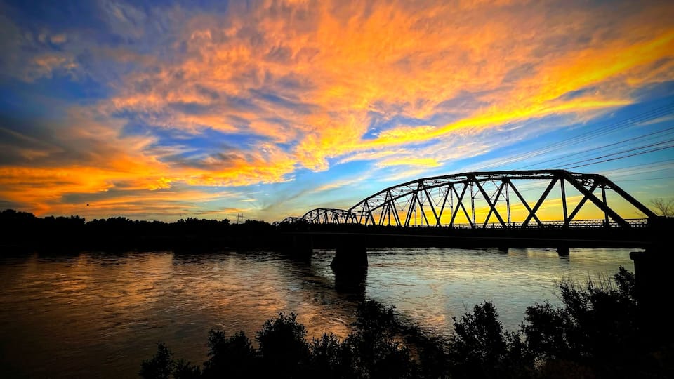 A Majestic Sunset over a Yellowstone River Bridge