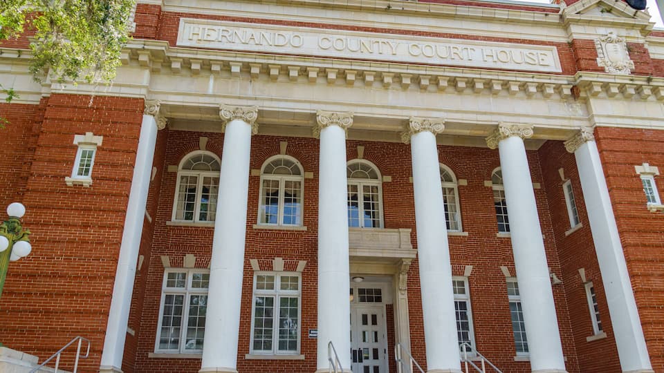 The Hernando County Court House with its red brick facade and white columns.