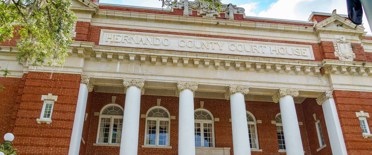 The Hernando County Court House with its red brick facade and white columns.