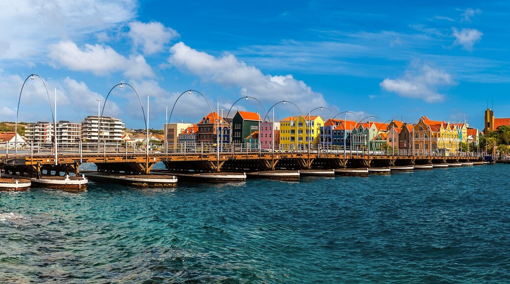 A panorama view across the Queen Emma Bridge over Saint Anna Bay towards the Punda District in Willemstad, Curacao on a bright morning
