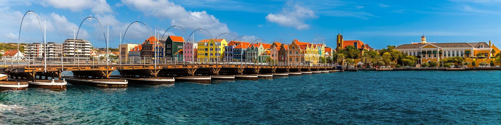 A panorama view across the Queen Emma Bridge over Saint Anna Bay towards the Punda District in Willemstad, Curacao on a bright morning
