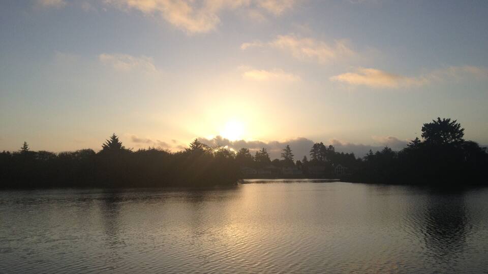 Break of day on Duck Lake in Ocean Shores. Deer family swims across from the islands just before sunrise