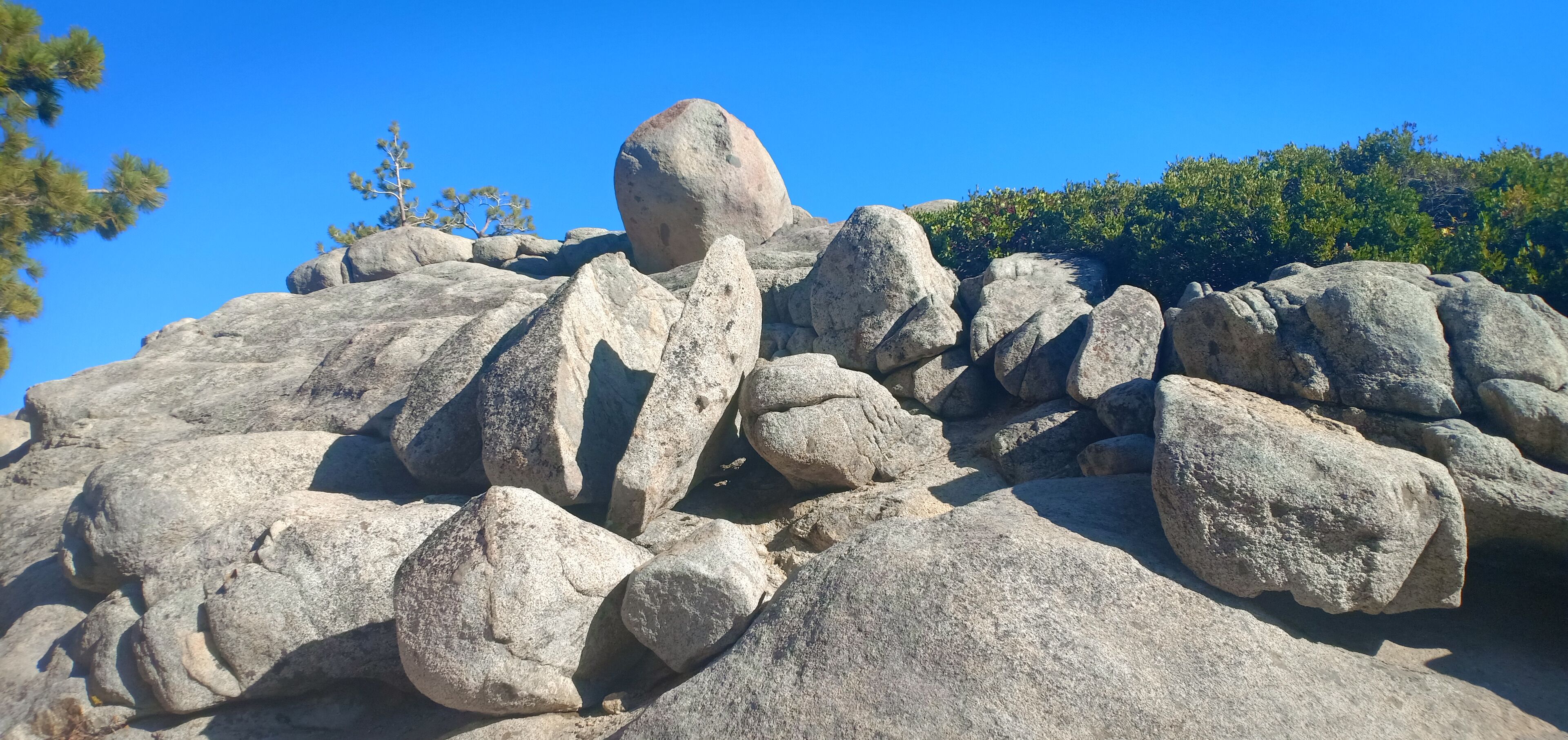 Large boulders and a clear blue sky.