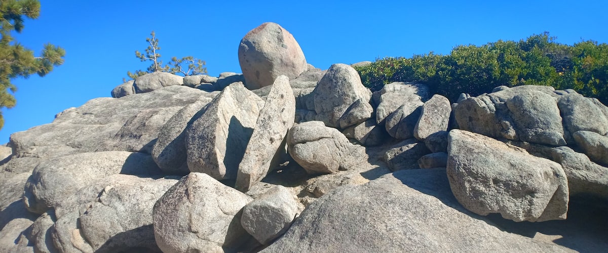 Large boulders and a clear blue sky.
