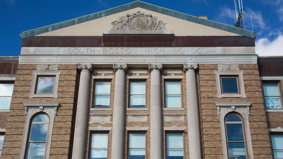 The South Boston High School building with classical architecture, including columns and a prominent entrance.