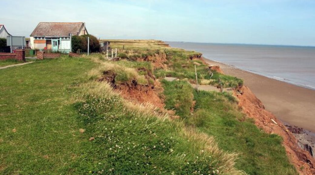 Road crumbling into the sea at Aldbrough, East Riding of Yorkshire, England. Empty house and a road falling away to the beach at Mount Pleasant Aldbrough.