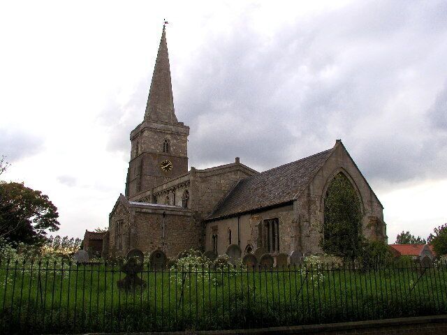 A historic church with a tall spire and a clock tower.