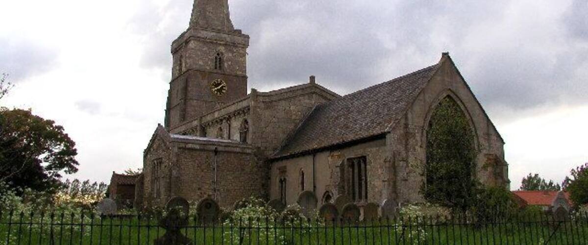 A historic church with a tall spire and a clock tower.