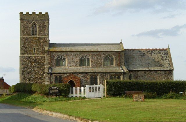 A historic stone church with a bell tower and arched windows.