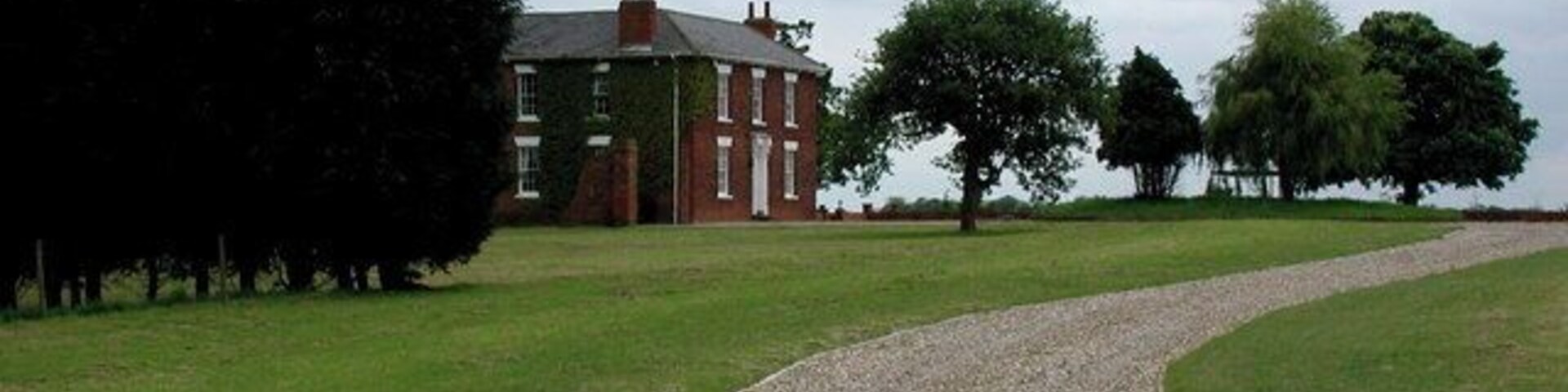 Fitling Grange, Fitling, East Riding of Yorkshire, England. The driveway to Fitling Grange on the south side of Humbleton Road. Fitling Grange was a 227 acre estate in 1874 when it was sold to the Hotham family, built on farmland acquired between 1787 and 1865 by former owners Christopher Kirkby and the Sykes family of Sledmere.